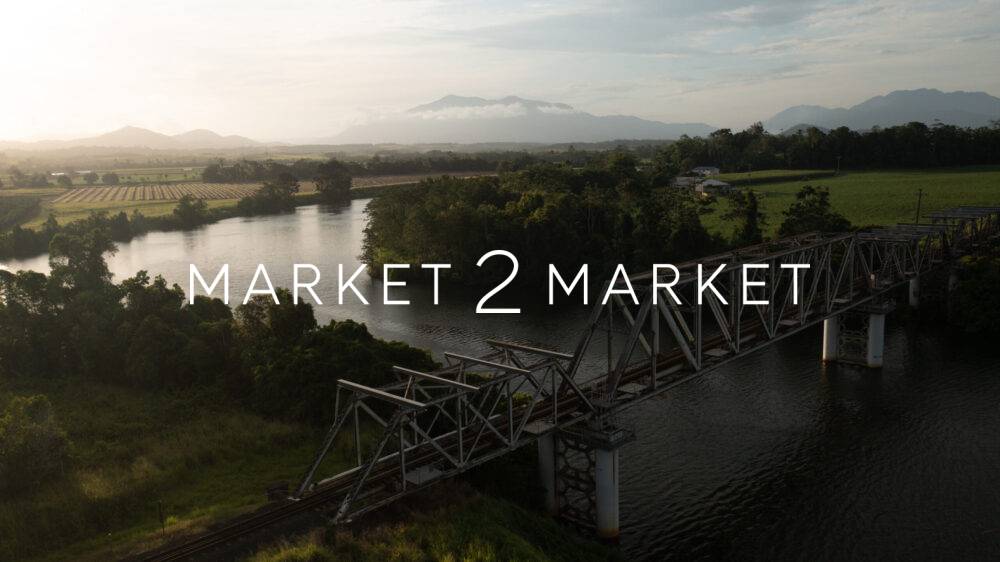 Aerial view of steel through-truss railway bridge crossing the winding Mulgrave River in the Goldsborough Valley