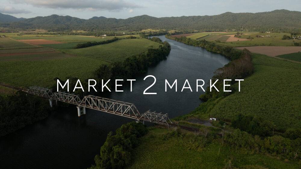 Aerial view of steel through-truss railway bridge crossing the winding Mulgrave River in the Goldsborough Valley